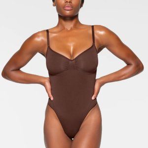 SKIMS Sculpting Thong Bodysuit | COCOA